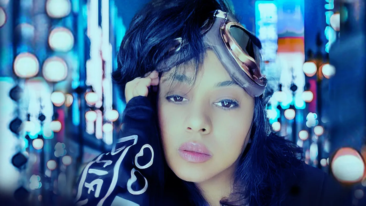 Anjalts with goggles pushed up on her head, a wall of city lights glowing blue behind