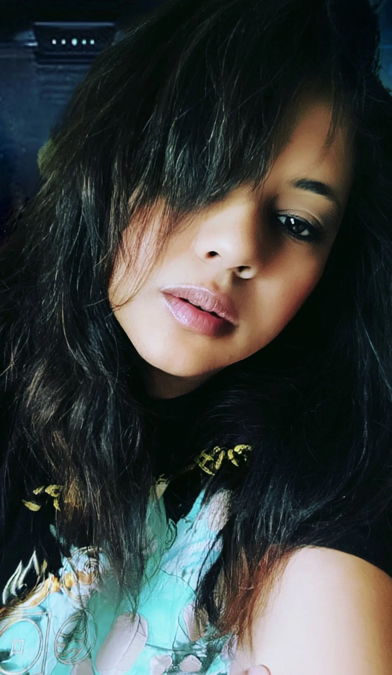 Anjalts — close portrait, dark hair falling across her face
