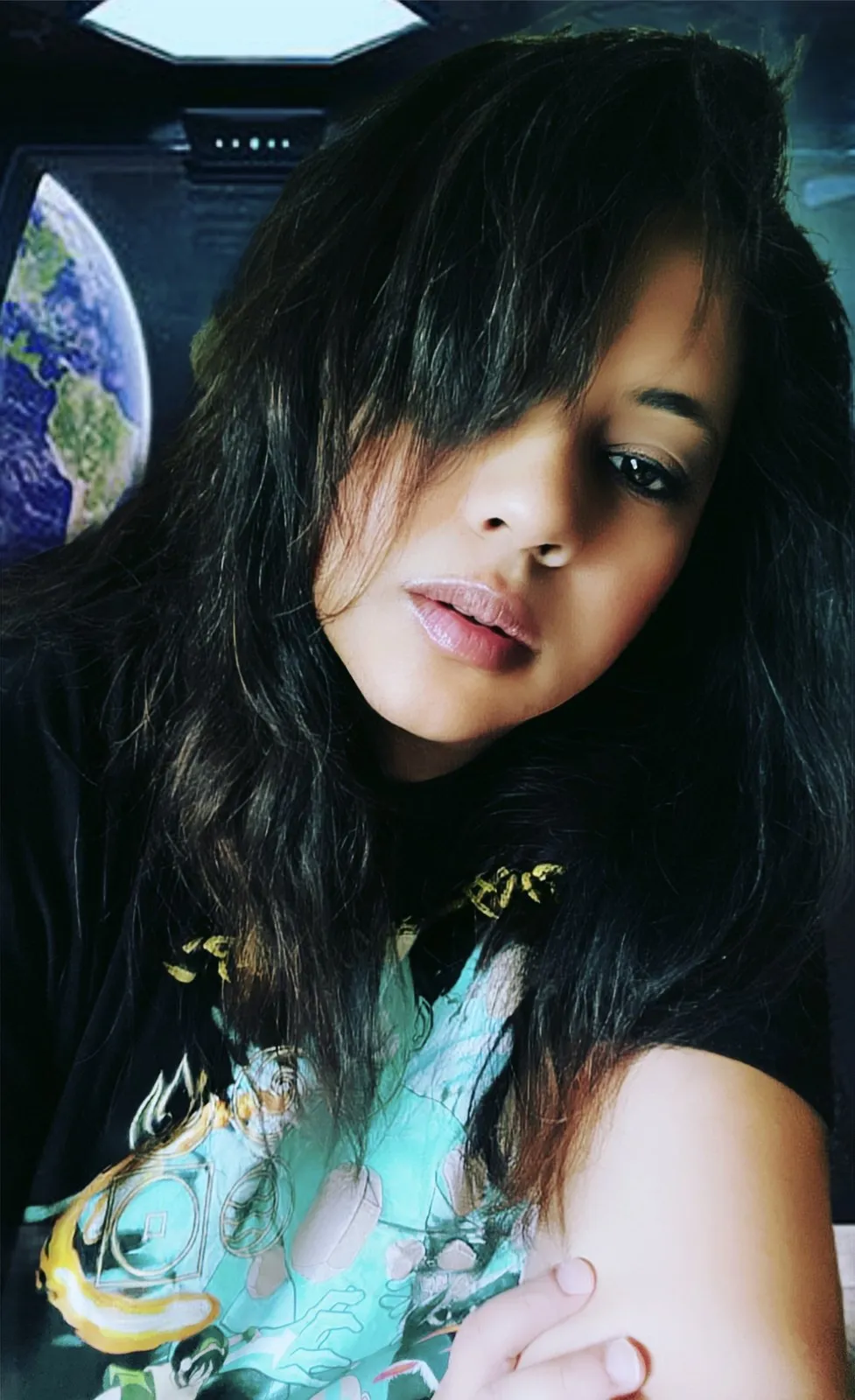 Anjalts — portrait in a dark hoodie printed with the Earth