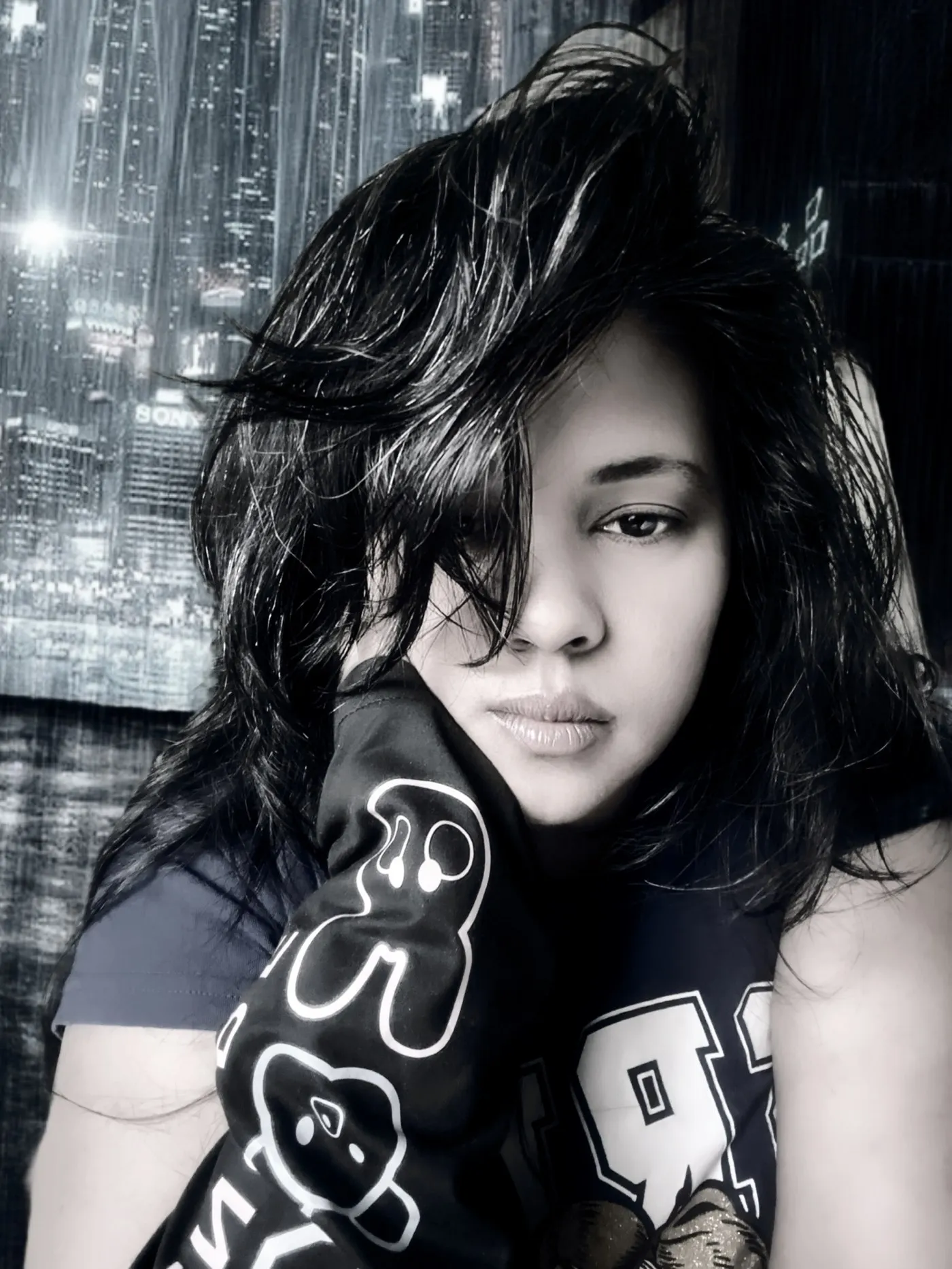 Anjalts — portrait, dark hoodie, city lights behind