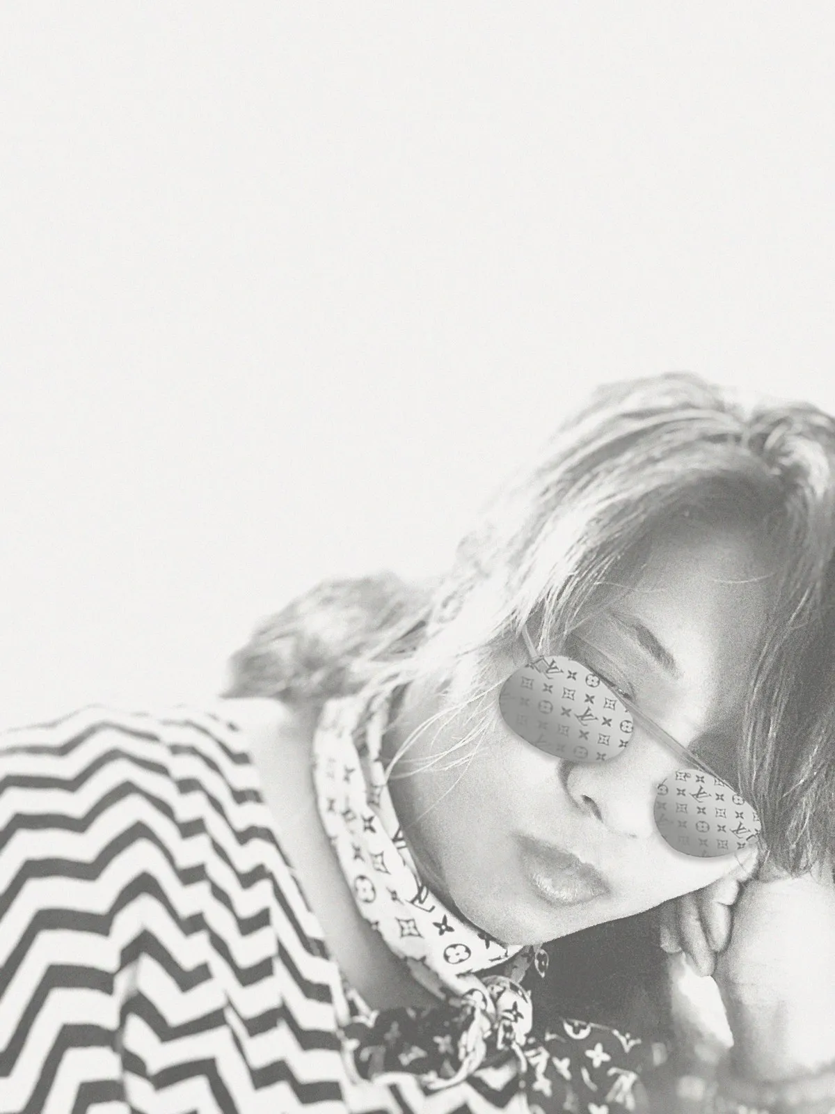 Anjalts in sunglasses and a scarf, high-key portrait