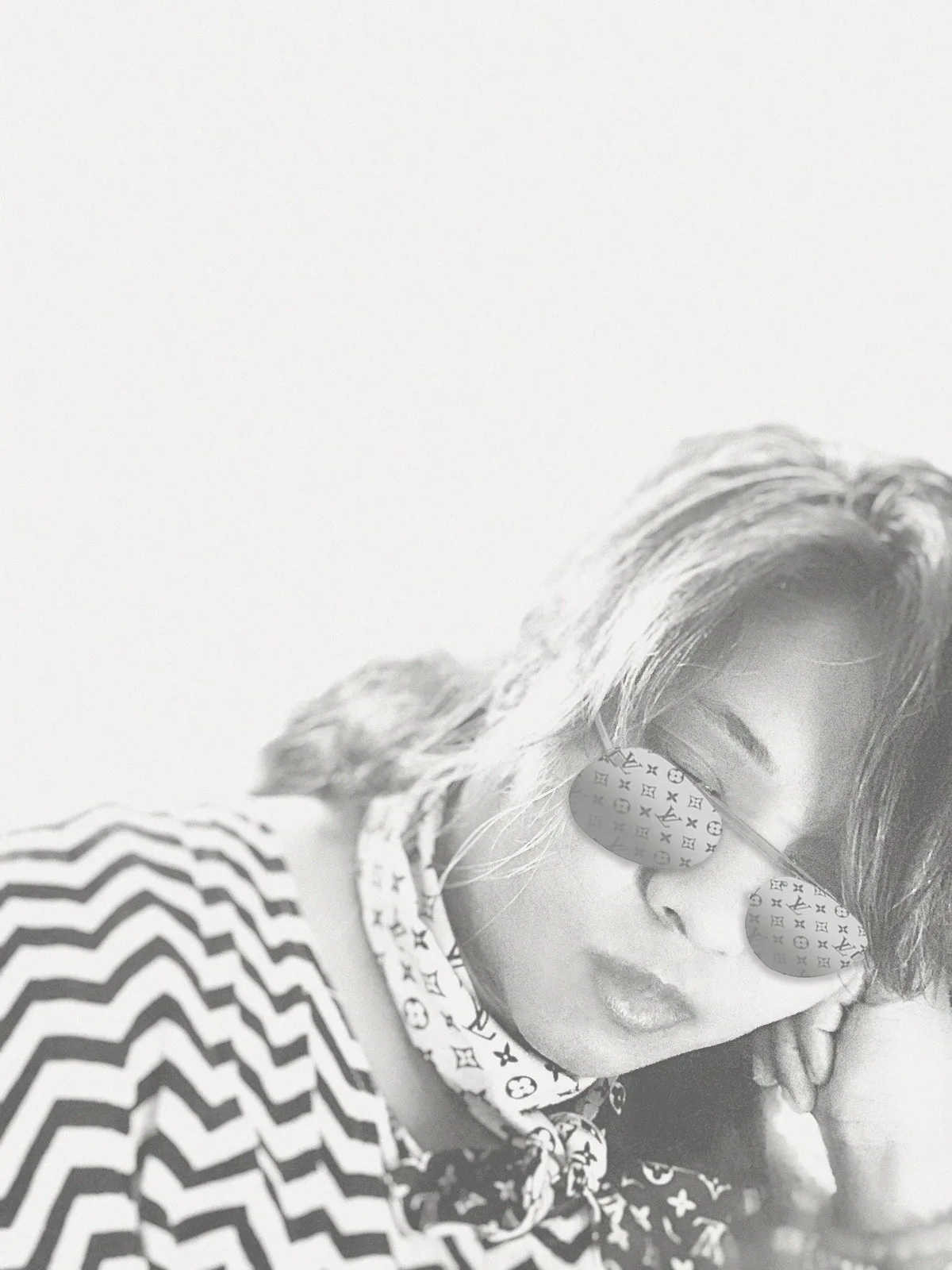 Anjalts in sunglasses and a scarf, high-key portrait